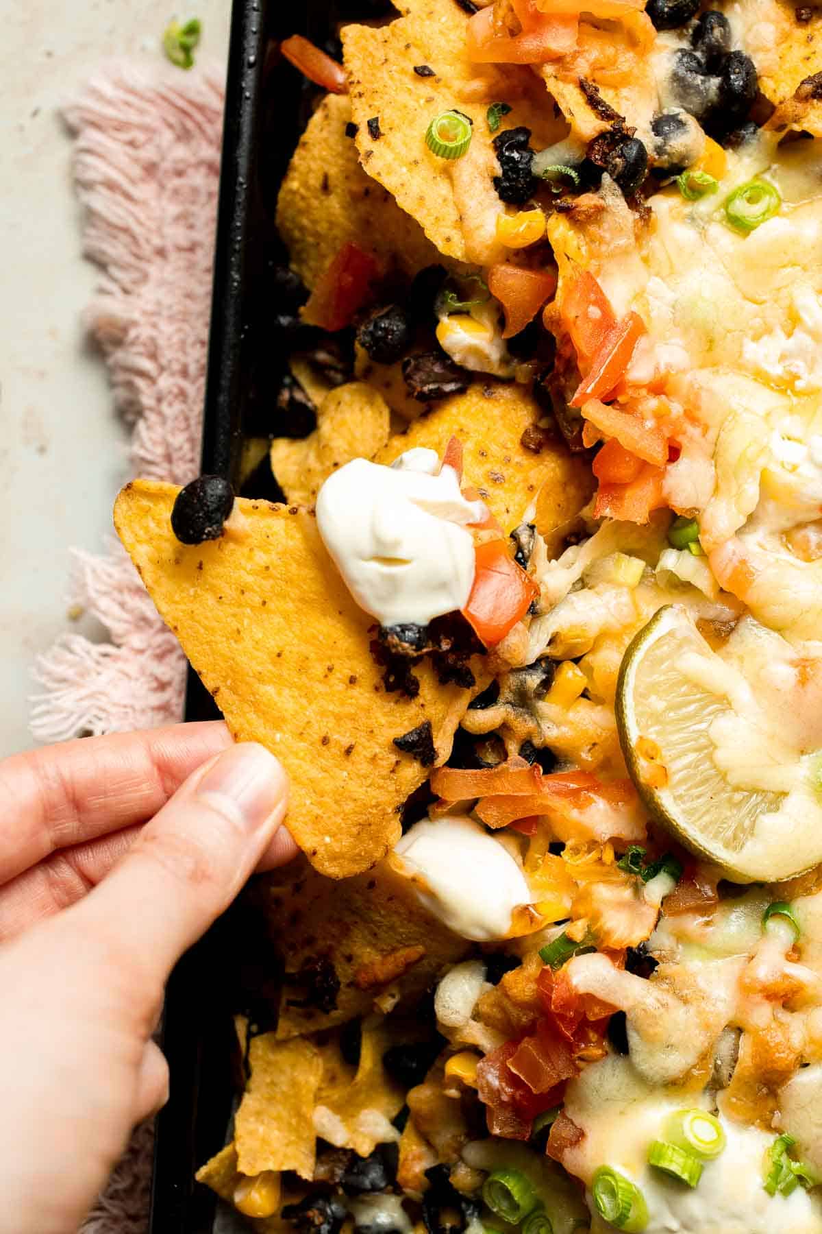 These loaded Black Bean Nachos are the ultimate vegetarian appetizer or snack — warm, crunchy, gooey, and so easy to make. | aheadofthyme.com