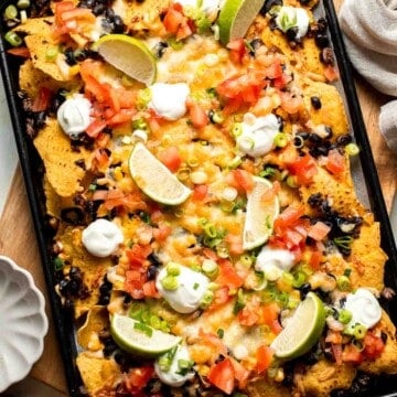 These loaded Black Bean Nachos are the ultimate vegetarian appetizer or snack — warm, crunchy, gooey, and so easy to make. | aheadofthyme.com