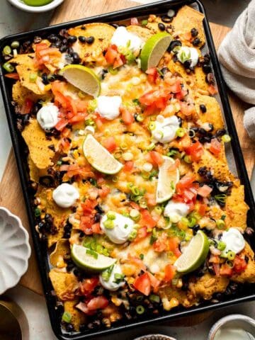 These loaded Black Bean Nachos are the ultimate vegetarian appetizer or snack — warm, crunchy, gooey, and so easy to make. | aheadofthyme.com
