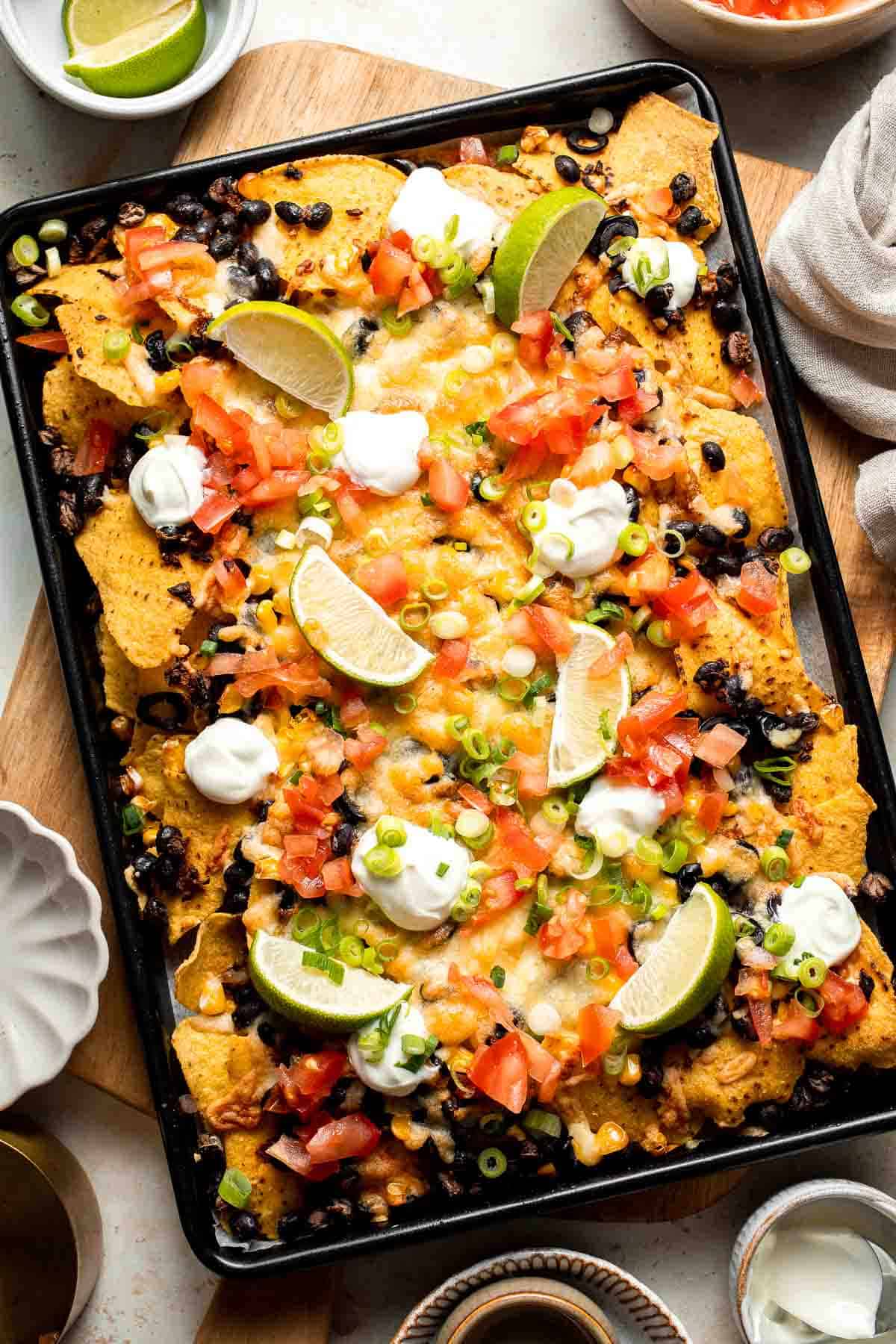 These loaded Black Bean Nachos are the ultimate vegetarian appetizer or snack — warm, crunchy, gooey, and so easy to make. | aheadofthyme.com