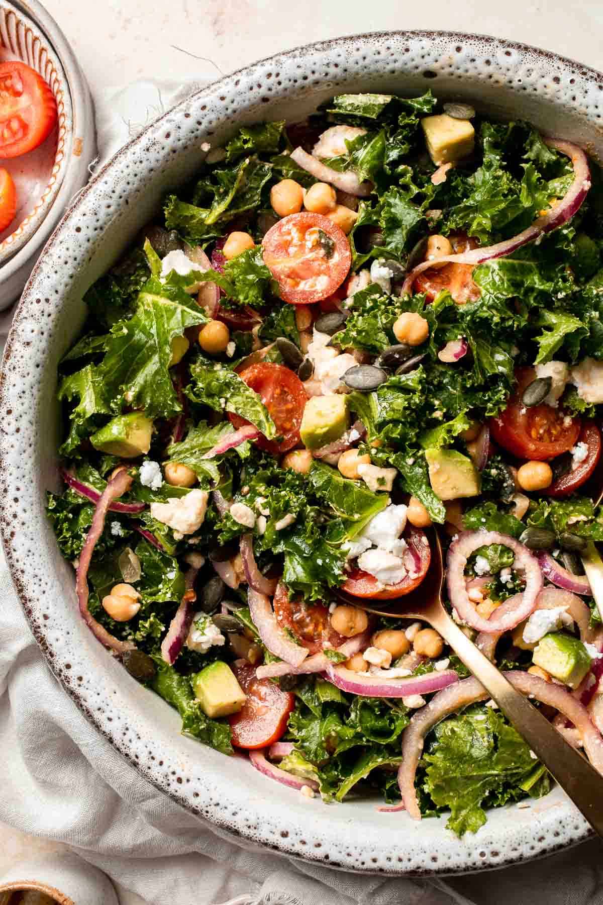 This Kale Chickpea Salad is light and refreshing, made with a mixture of fresh veggies, chickpeas, tangy feta, and a homemade lemon dijon vinaigrette. | aheadofthyme.com