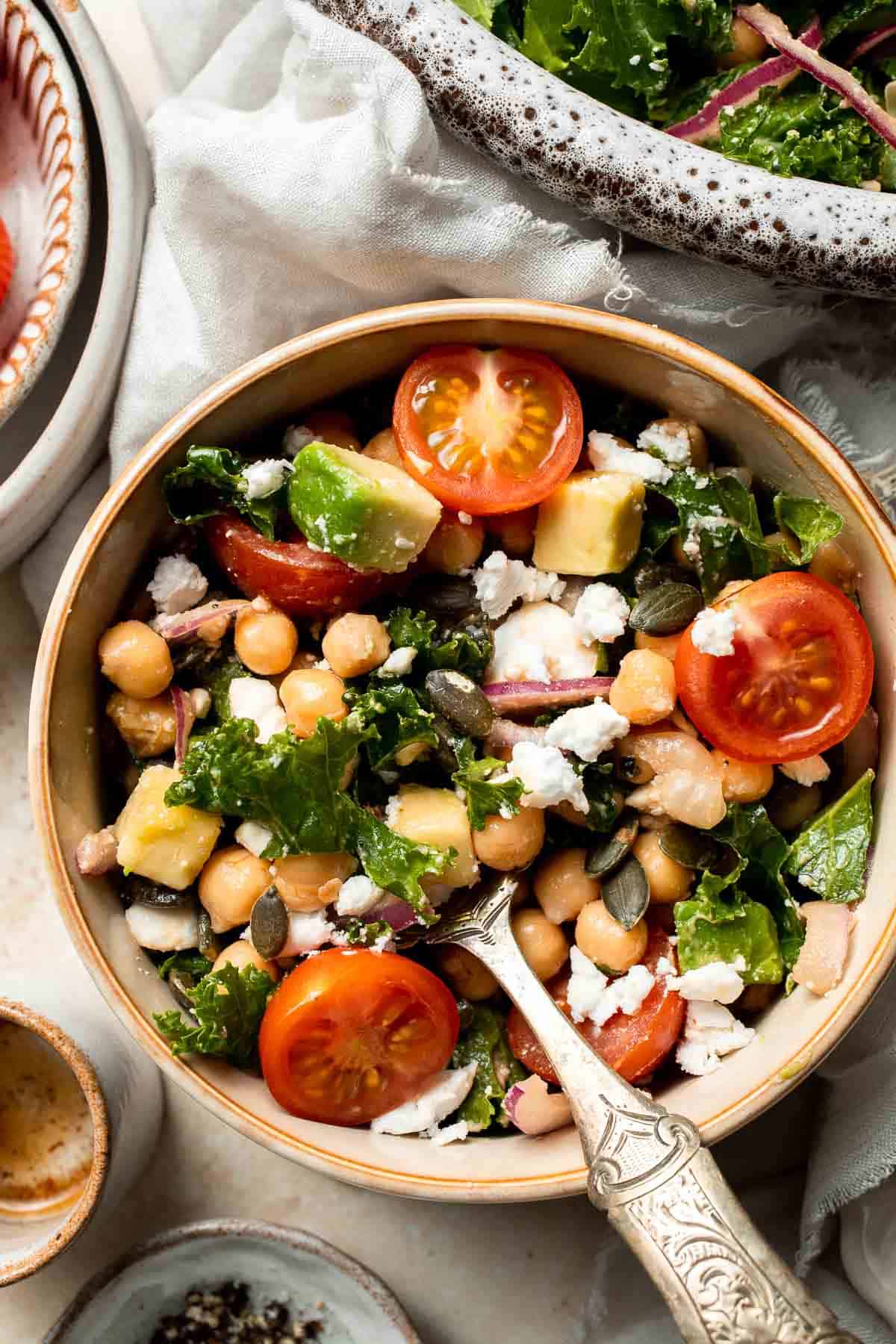 This Kale Chickpea Salad is light and refreshing, made with a mixture of fresh veggies, chickpeas, tangy feta, and a homemade lemon dijon vinaigrette. | aheadofthyme.com