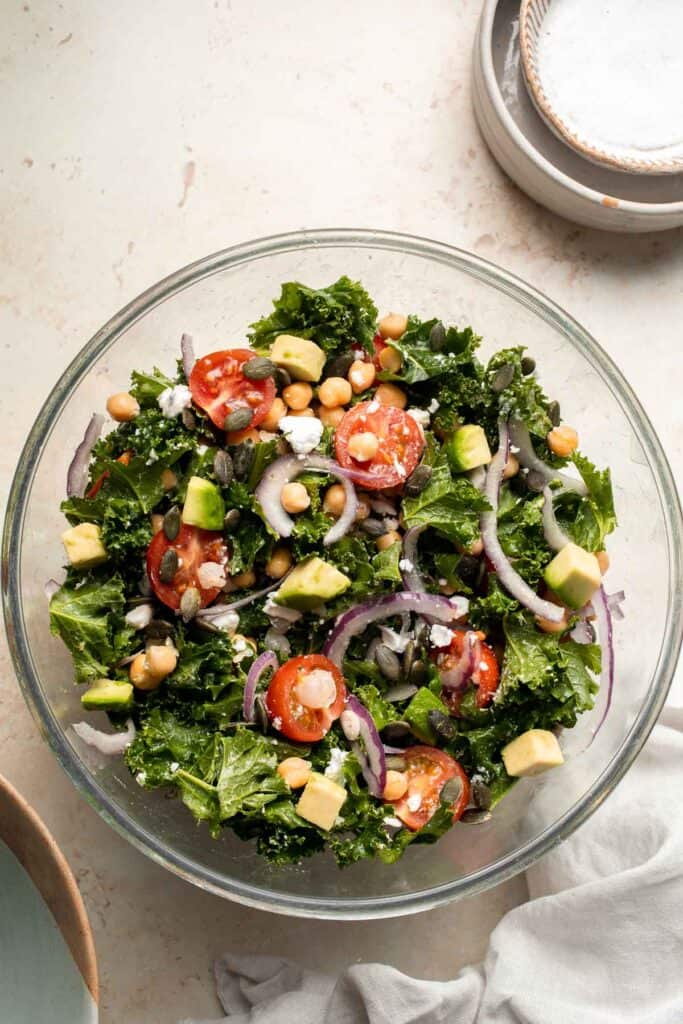 This Kale Chickpea Salad is light and refreshing, made with a mixture of fresh veggies, chickpeas, tangy feta, and a homemade lemon dijon vinaigrette. | aheadofthyme.com