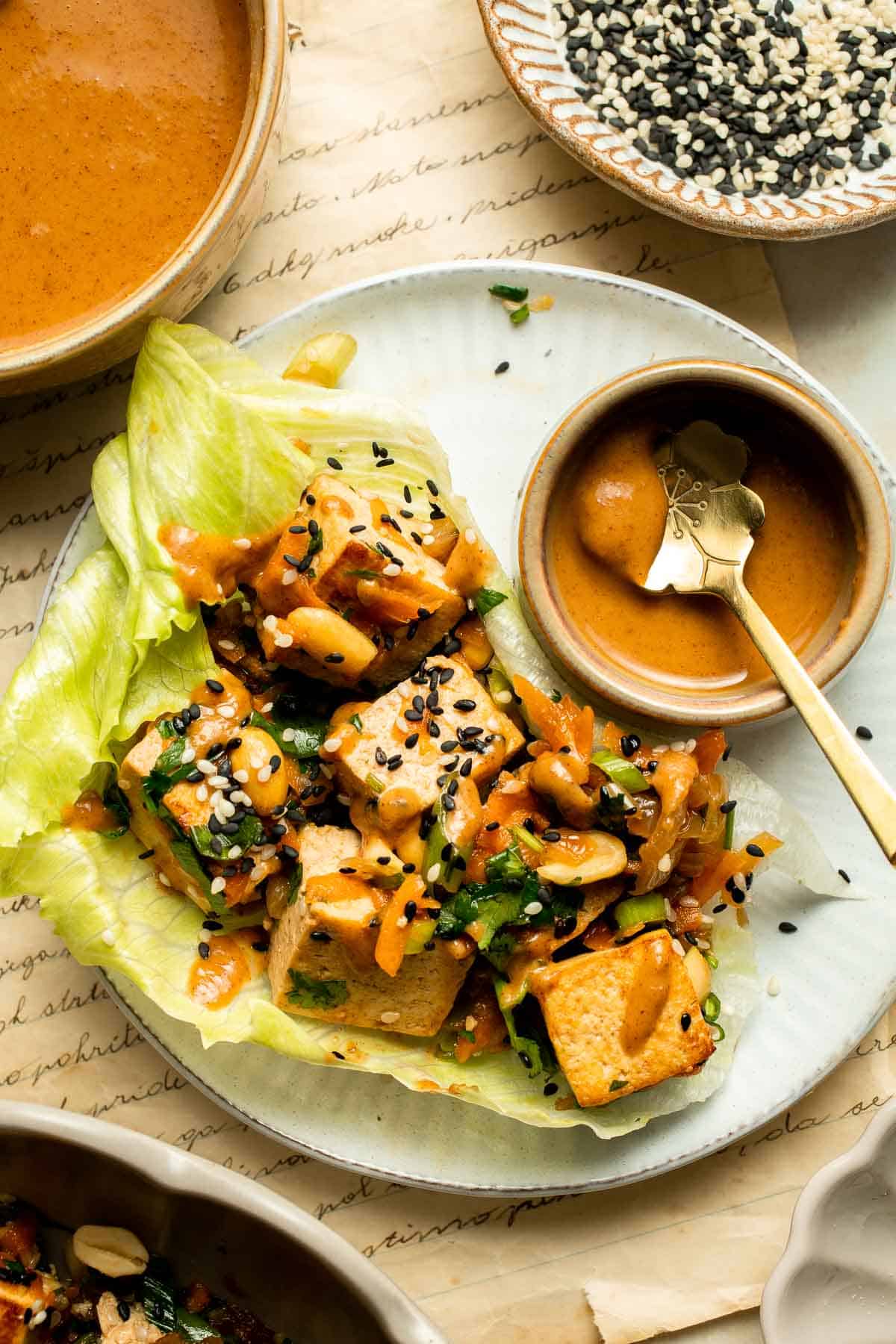 Tofu Lettuce Wraps are filled with a vegan filling of tofu, veggies, and homemade peanut sauce for the best balance of textures and flavors. | aheadofthyme.com