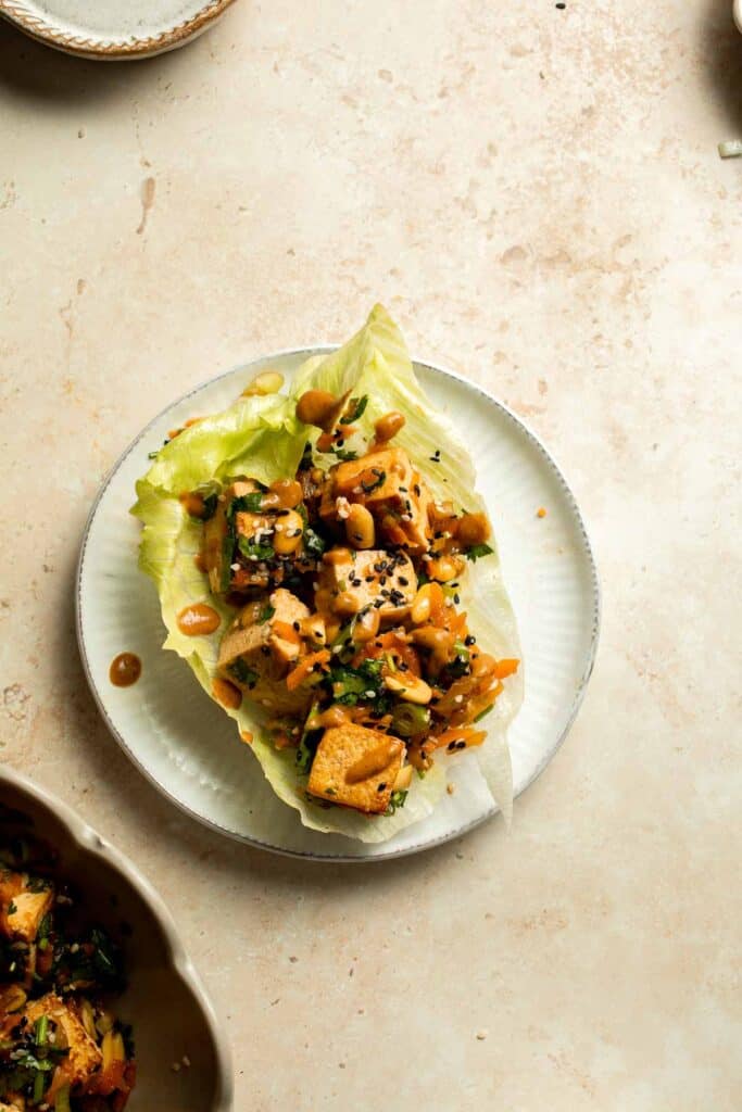Tofu Lettuce Wraps are filled with a vegan filling of tofu, veggies, and homemade peanut sauce for the best balance of textures and flavors. | aheadofthyme.com