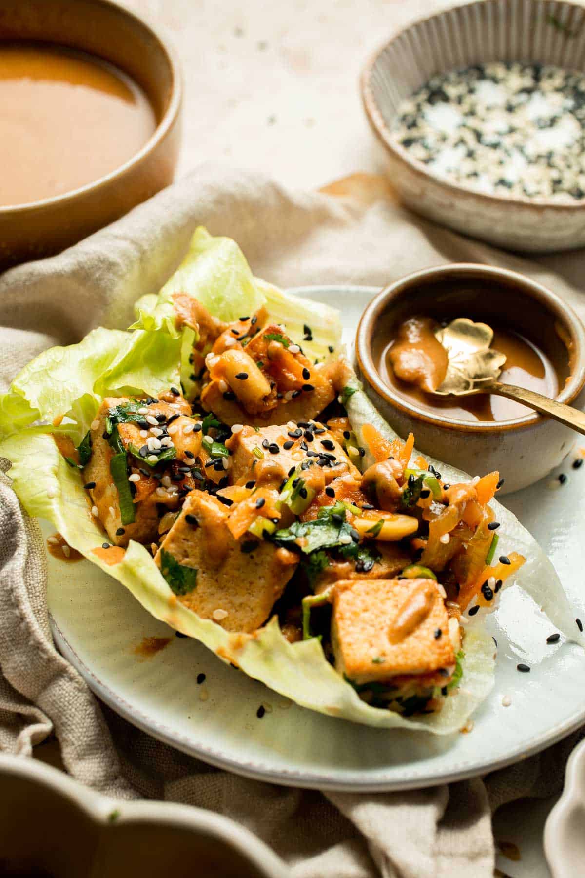 Tofu Lettuce Wraps are filled with a vegan filling of tofu, veggies, and homemade peanut sauce for the best balance of textures and flavors. | aheadofthyme.com