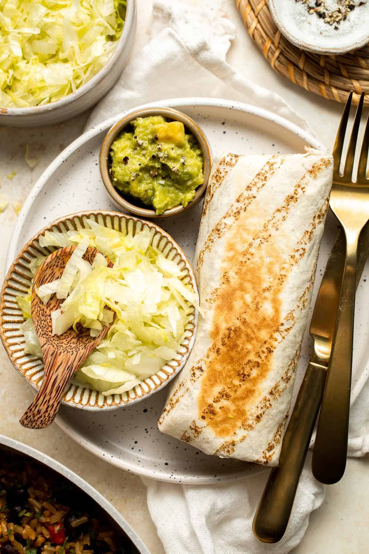 Easy homemade Vegan Burritos are the most flavorful version of beans and rice you've had, all rolled up in a large tortilla and served with homemade guac. | aheadofthyme.com