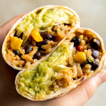 Easy homemade Vegan Burritos are the most flavorful version of beans and rice you've had, all rolled up in a large tortilla and served with homemade guac. | aheadofthyme.com
