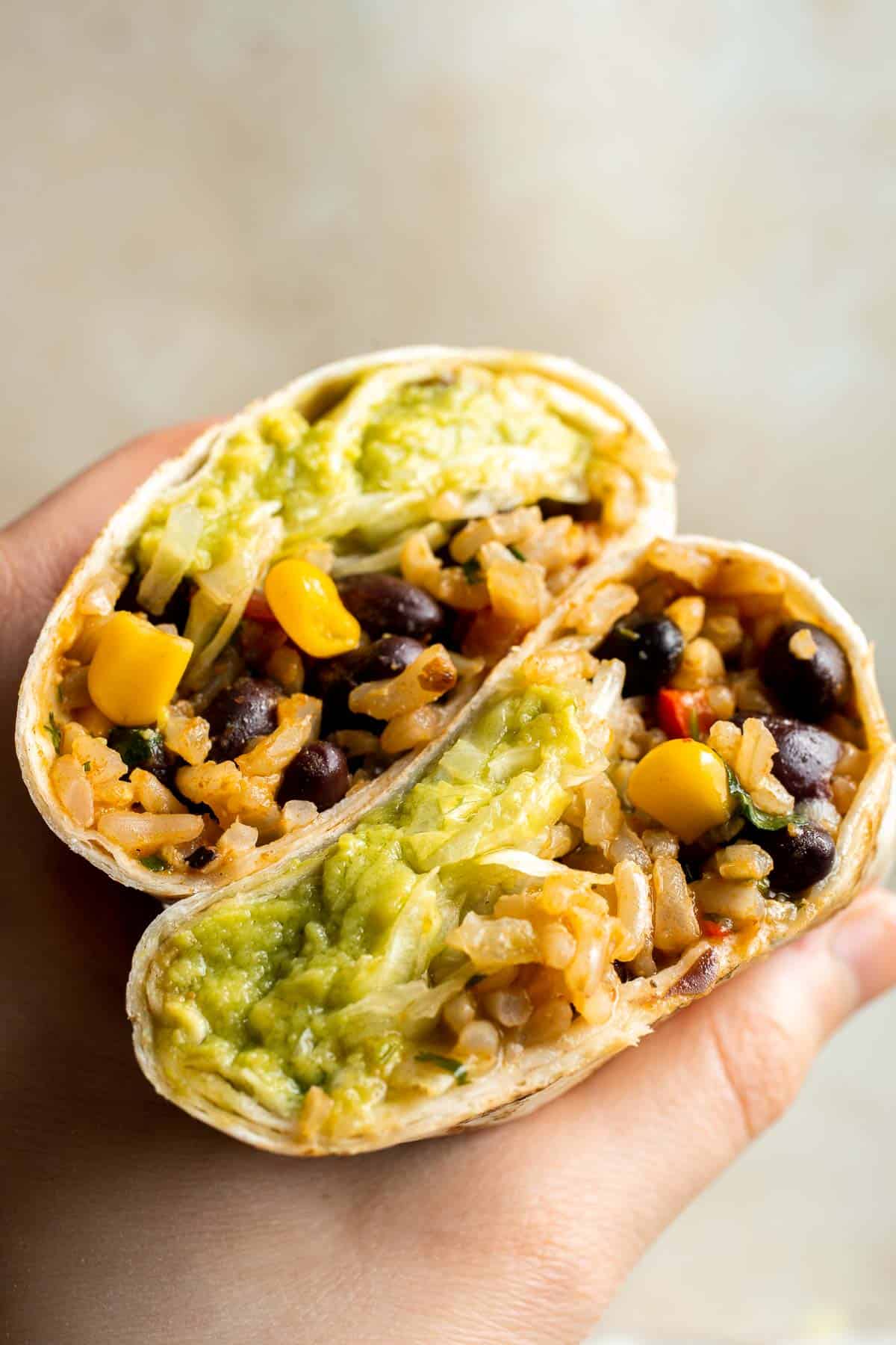 Easy homemade Vegan Burritos are the most flavorful version of beans and rice you've had, all rolled up in a large tortilla and served with homemade guac. | aheadofthyme.com