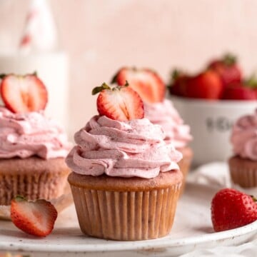 Strawberry Cupcakes are made with real strawberries in both the tender cake batter and the creamy strawberry buttercream frosting. A picture-perfect treat! | aheadofthyme.com