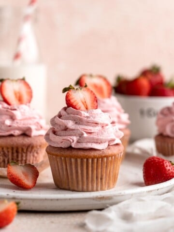 Strawberry Cupcakes are made with real strawberries in both the tender cake batter and the creamy strawberry buttercream frosting. A picture-perfect treat! | aheadofthyme.com
