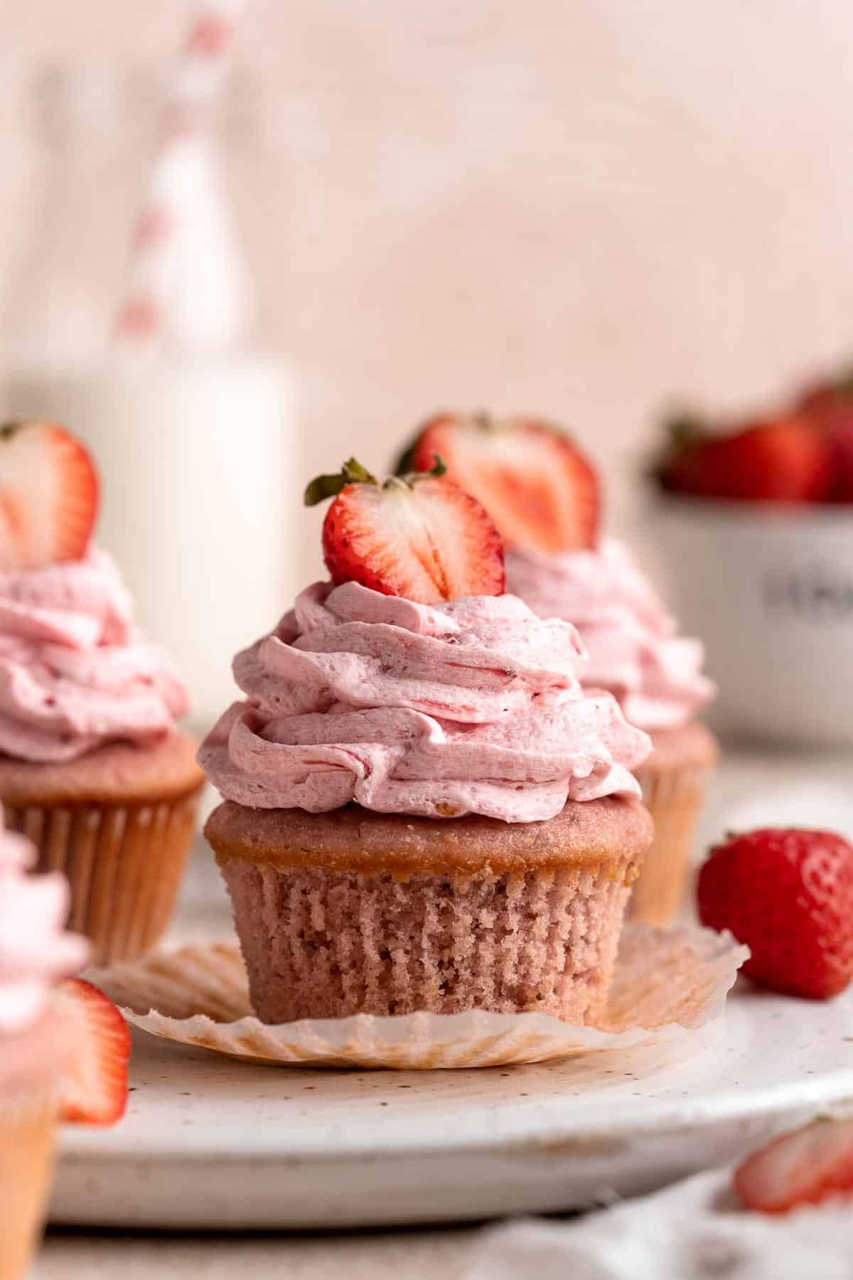 Strawberry Cupcakes are made with real strawberries in both the tender cake batter and the creamy strawberry buttercream frosting. A picture-perfect treat! | aheadofthyme.com