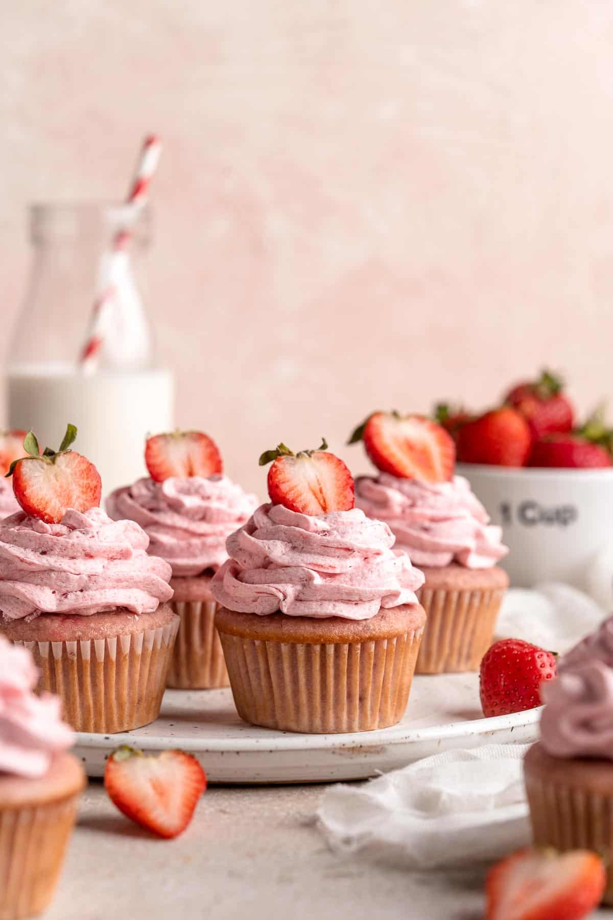 Strawberry Cupcakes are made with real strawberries in both the tender cake batter and the creamy strawberry buttercream frosting. A picture-perfect treat! | aheadofthyme.com