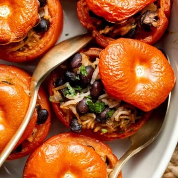 Stuffed Tomatoes are a simple vegetarian meal made with fresh tomatoes stuffed with a comforting mixture of beans and rice, and baked to perfection. | aheadofthyme.com