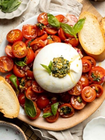 Tomato Burrata Salad is made with ultra creamy burrata over a bed of marinated tomatoes and onions and a drizzle of fresh basil pesto on top. So fresh! | aheadofthyme.com