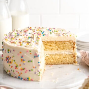 This moist and tender, two layer Vanilla Cake is a classic choice topped with the fluffiest, creamiest vanilla buttercream frosting. Perfect for birthdays! | aheadofthyme.com
