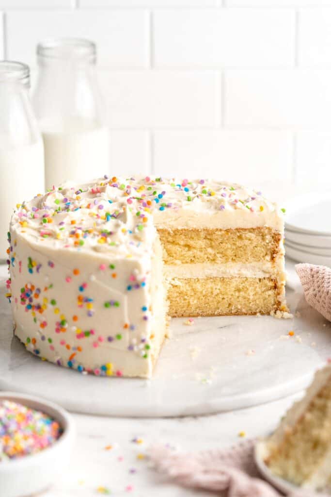 This moist and tender, two layer Vanilla Cake is a classic choice topped with the fluffiest, creamiest vanilla buttercream frosting. Perfect for birthdays! | aheadofthyme.com
