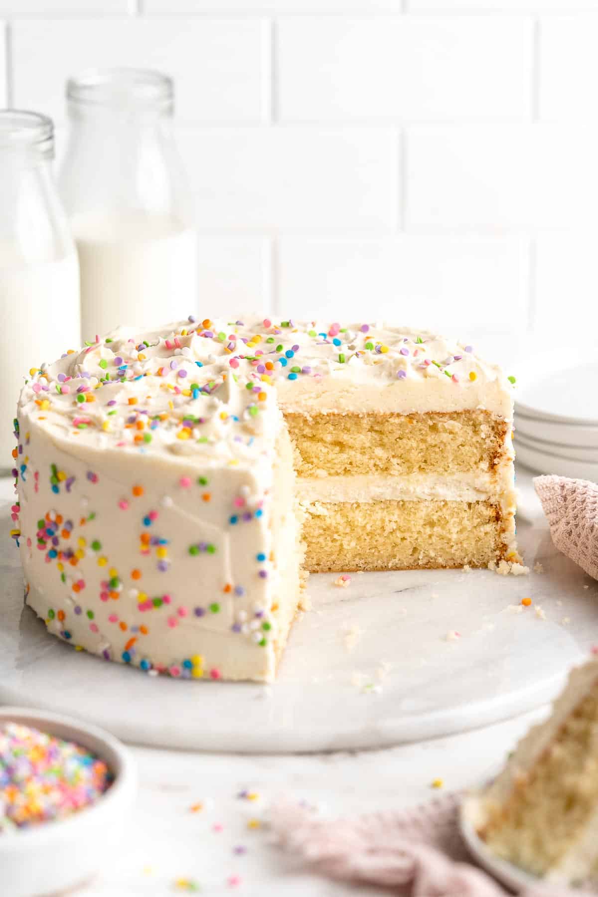 This moist and tender, two layer Vanilla Cake is a classic choice topped with the fluffiest, creamiest vanilla buttercream frosting. Perfect for birthdays! | aheadofthyme.com