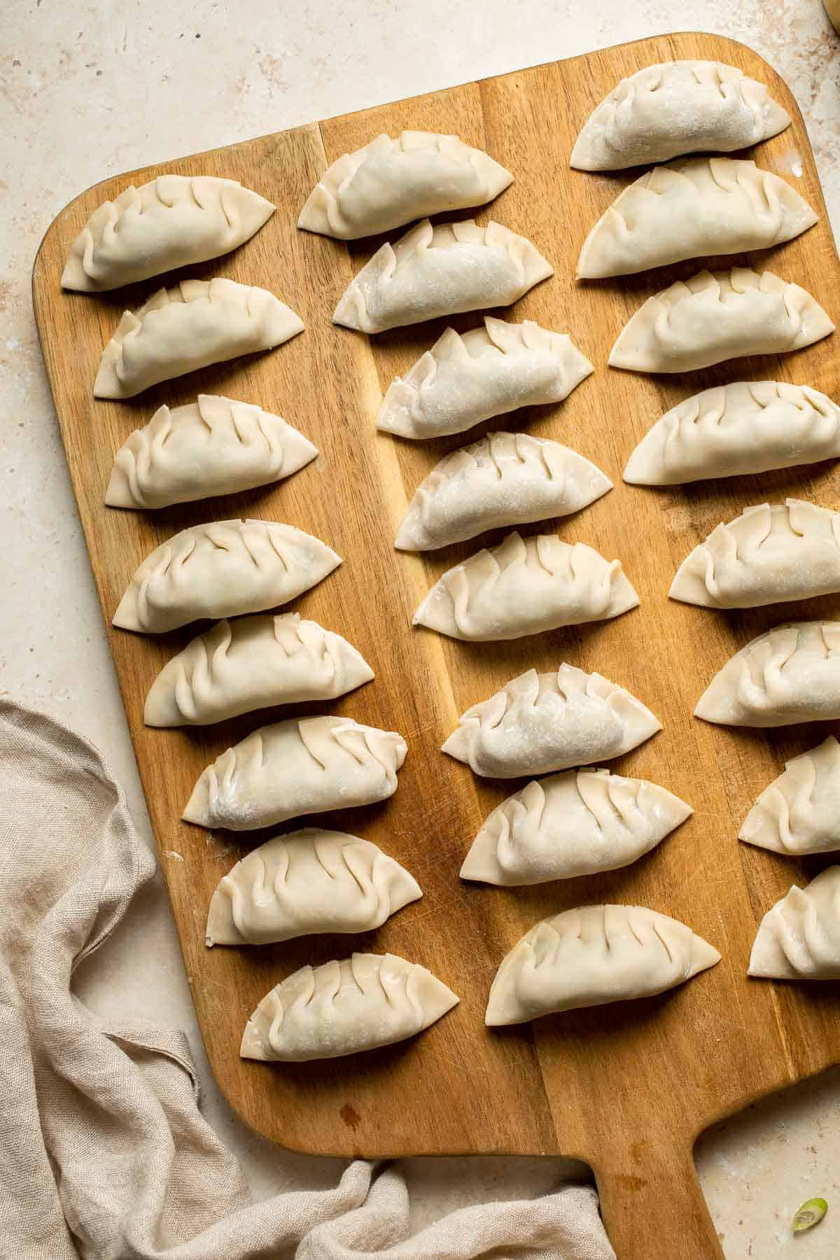 Made with a savory vegan mixture of mushrooms, cabbage, carrots, and more, these homemade Vegetable Dumplings are meaty and satisfying — without any meat! | aheadofthyme.com