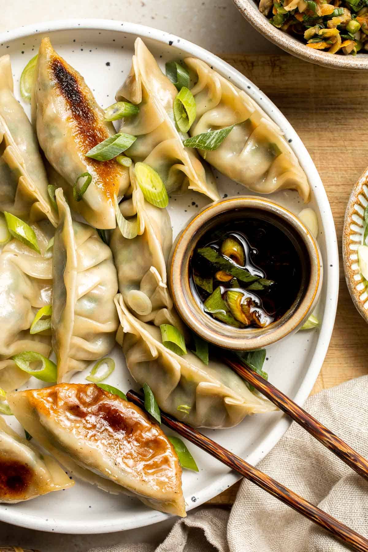 Made with a savory vegan mixture of mushrooms, cabbage, carrots, and more, these homemade Vegetable Dumplings are meaty and satisfying — without any meat! | aheadofthyme.com