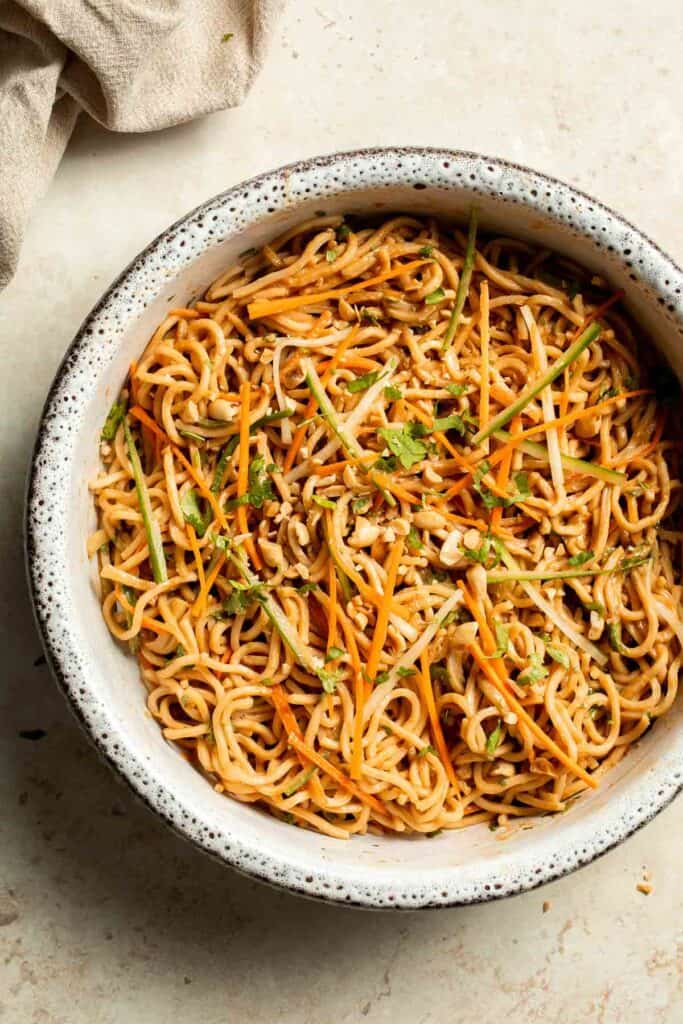 Flavorful, crispy, and crunchy, this Asian Cold Noodle Salad is made with noodles, vegetables, peanuts, and cilantro tossed in a homemade peanut dressing. | aheadofthyme.com