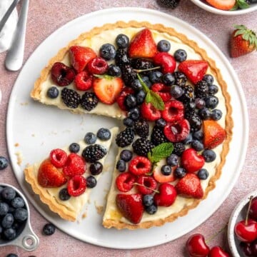 This Fresh Fruit Tart is made with a homemade sugar cookie crust, filled with a sweet vanilla custard and topped with fresh seasonal fruit. | aheadofthyme.com