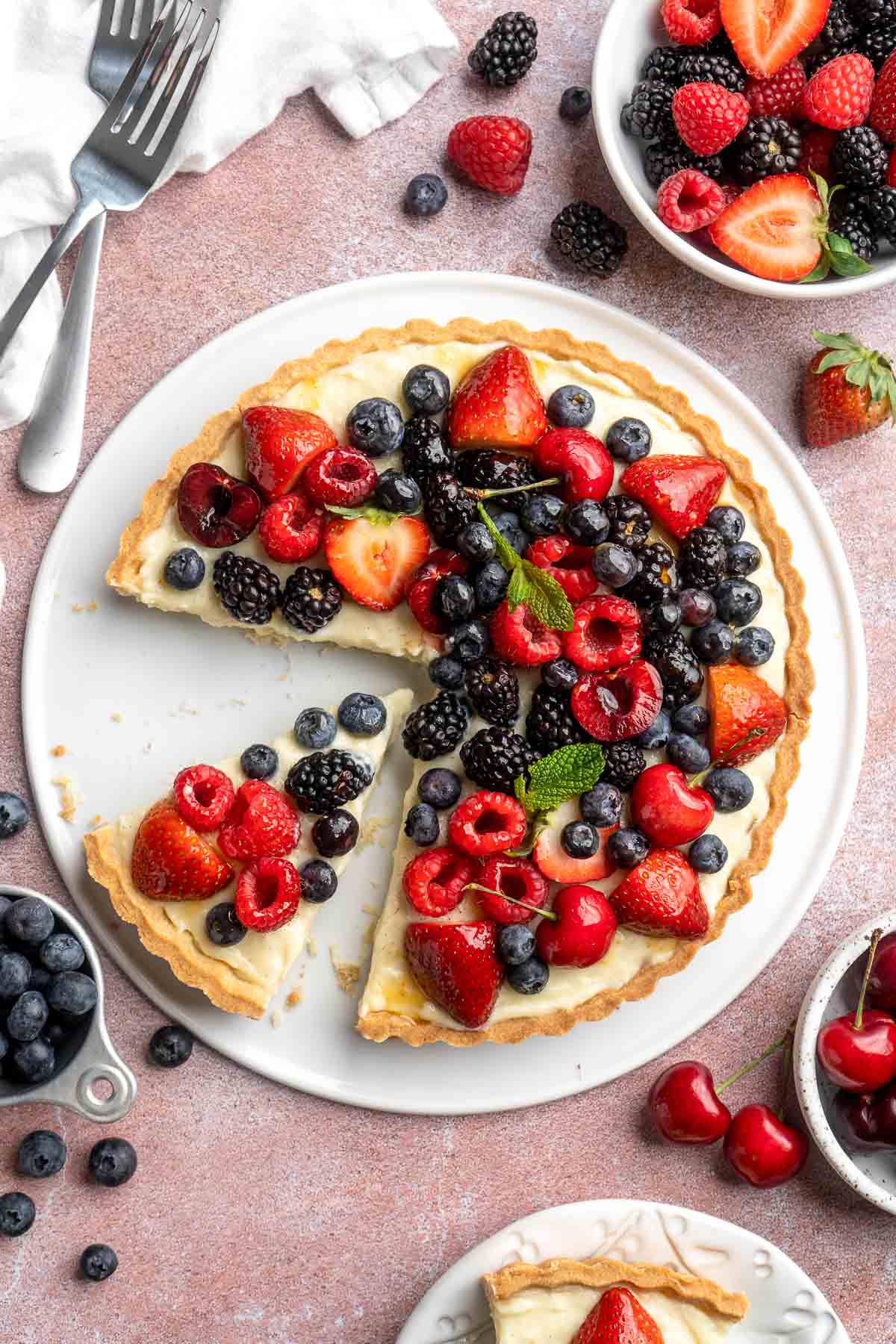 This Fresh Fruit Tart is made with a homemade sugar cookie crust, filled with a sweet vanilla custard and topped with fresh seasonal fruit. | aheadofthyme.com