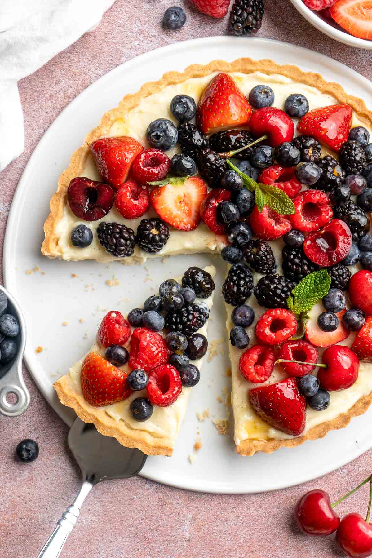 This Fresh Fruit Tart is made with a homemade sugar cookie crust, filled with a sweet vanilla custard and topped with fresh seasonal fruit. | aheadofthyme.com