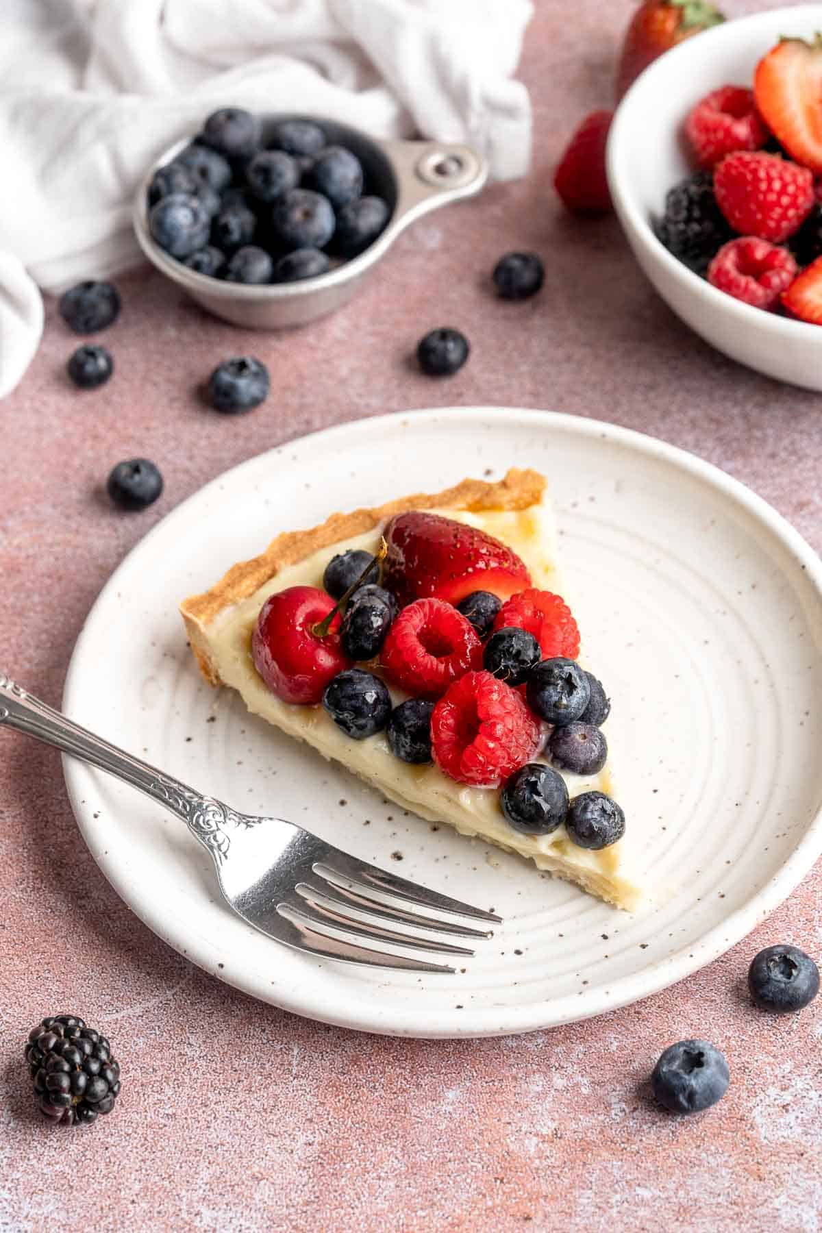 This Fresh Fruit Tart is made with a homemade sugar cookie crust, filled with a sweet vanilla custard and topped with fresh seasonal fruit. | aheadofthyme.com