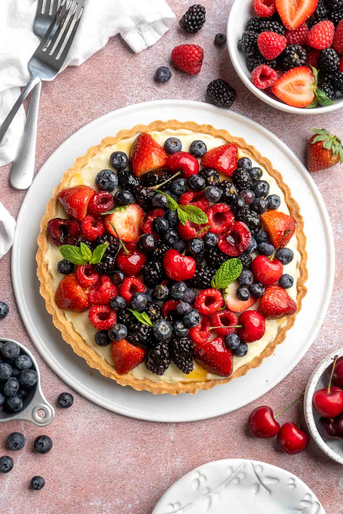 This Fresh Fruit Tart is made with a homemade sugar cookie crust, filled with a sweet vanilla custard and topped with fresh seasonal fruit. | aheadofthyme.com