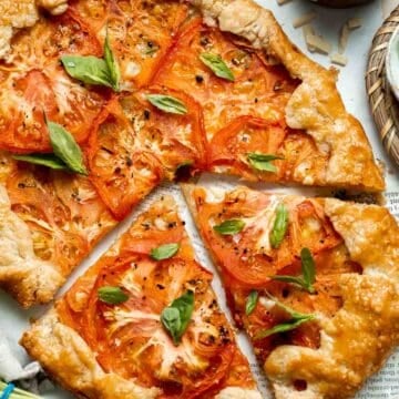 Tomato Galette is the ultimate celebration of summer, made with a buttery, flaky crust, a thin layer of cheese, and a bed of colorful heirloom tomatoes. | aheadofthyme.com