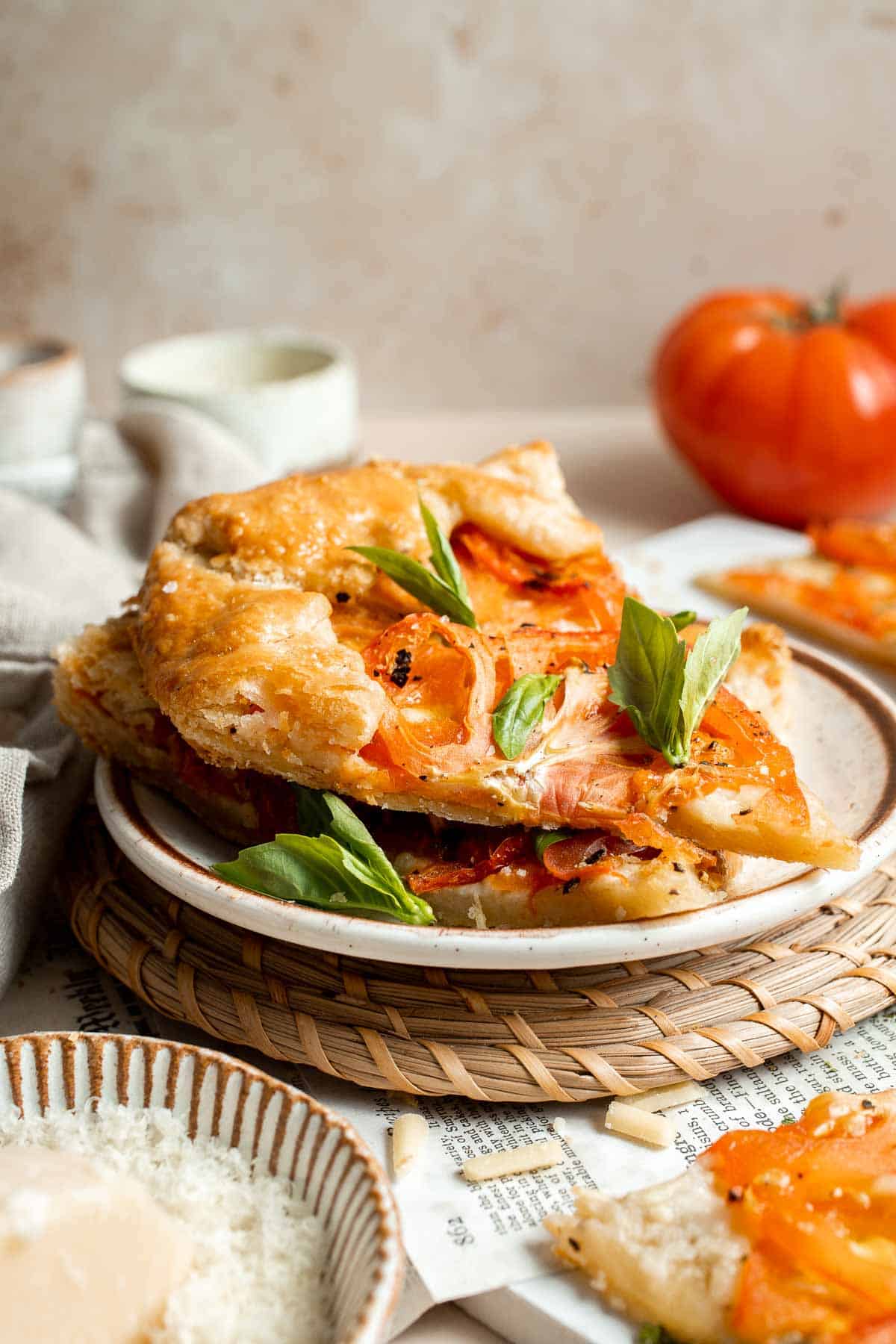 Tomato Galette is the ultimate celebration of summer, made with a buttery, flaky crust, a thin layer of cheese, and a bed of colorful heirloom tomatoes. | aheadofthyme.com