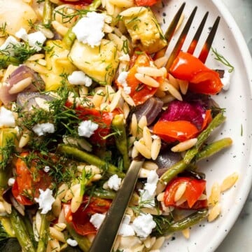 This Vegetable Orzo is easy to make with seasonal vegetables that are roasted then topped with warm fluffy orzo, feta cheese, and fresh herbs. | aheadofthyme.com