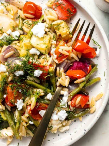 This Vegetable Orzo is easy to make with seasonal vegetables that are roasted then topped with warm fluffy orzo, feta cheese, and fresh herbs. | aheadofthyme.com