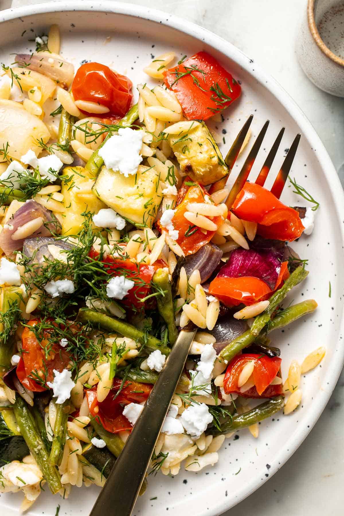 This Vegetable Orzo is easy to make with seasonal vegetables that are roasted then topped with warm fluffy orzo, feta cheese, and fresh herbs. | aheadofthyme.com