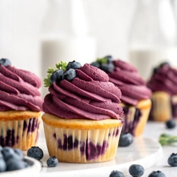 Blueberry Cupcakes are a homemade treat with moist and tender vanilla cupcake batter loaded with fresh blueberries and topped with blueberry buttercream. | aheadofthyme.com
