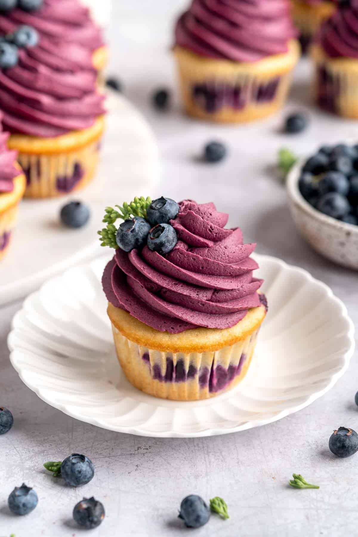 Blueberry Cupcakes are a homemade treat with moist and tender vanilla cupcake batter loaded with fresh blueberries and topped with blueberry buttercream. | aheadofthyme.com