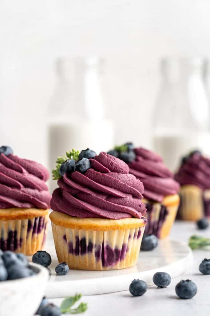 Blueberry Cupcakes are a homemade treat with moist and tender vanilla cupcake batter loaded with fresh blueberries and topped with blueberry buttercream. | aheadofthyme.com