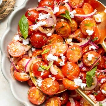 This quick and easy Cherry Tomato Salad is made with sweet cherry tomatoes, red onion, fresh basil, and feta cheese tossed in a simple vinaigrette. | aheadofthyme.com