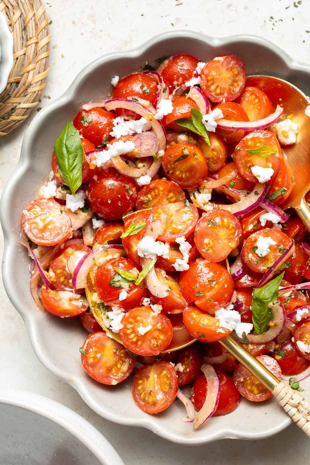 This quick and easy Cherry Tomato Salad is made with sweet cherry tomatoes, red onion, fresh basil, and feta cheese tossed in a simple vinaigrette. | aheadofthyme.com