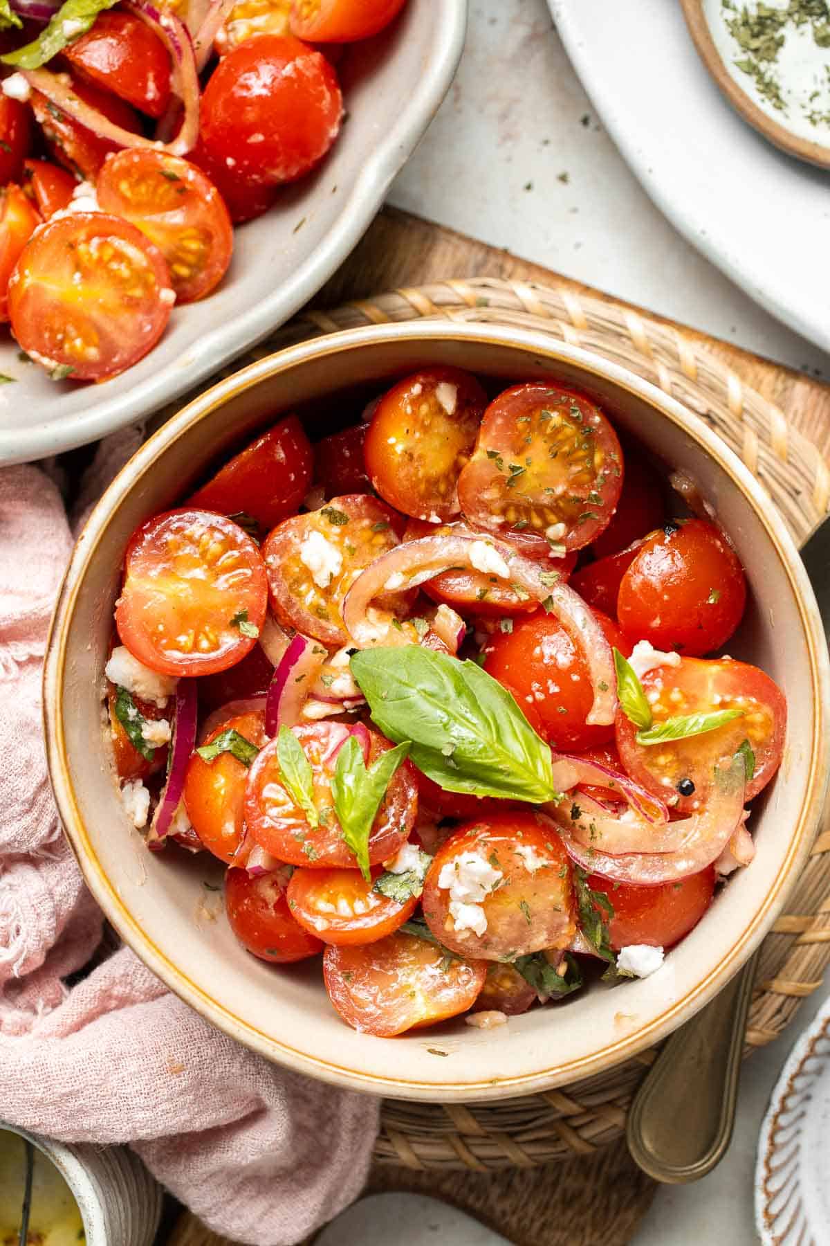This quick and easy Cherry Tomato Salad is made with sweet cherry tomatoes, red onion, fresh basil, and feta cheese tossed in a simple vinaigrette. | aheadofthyme.com