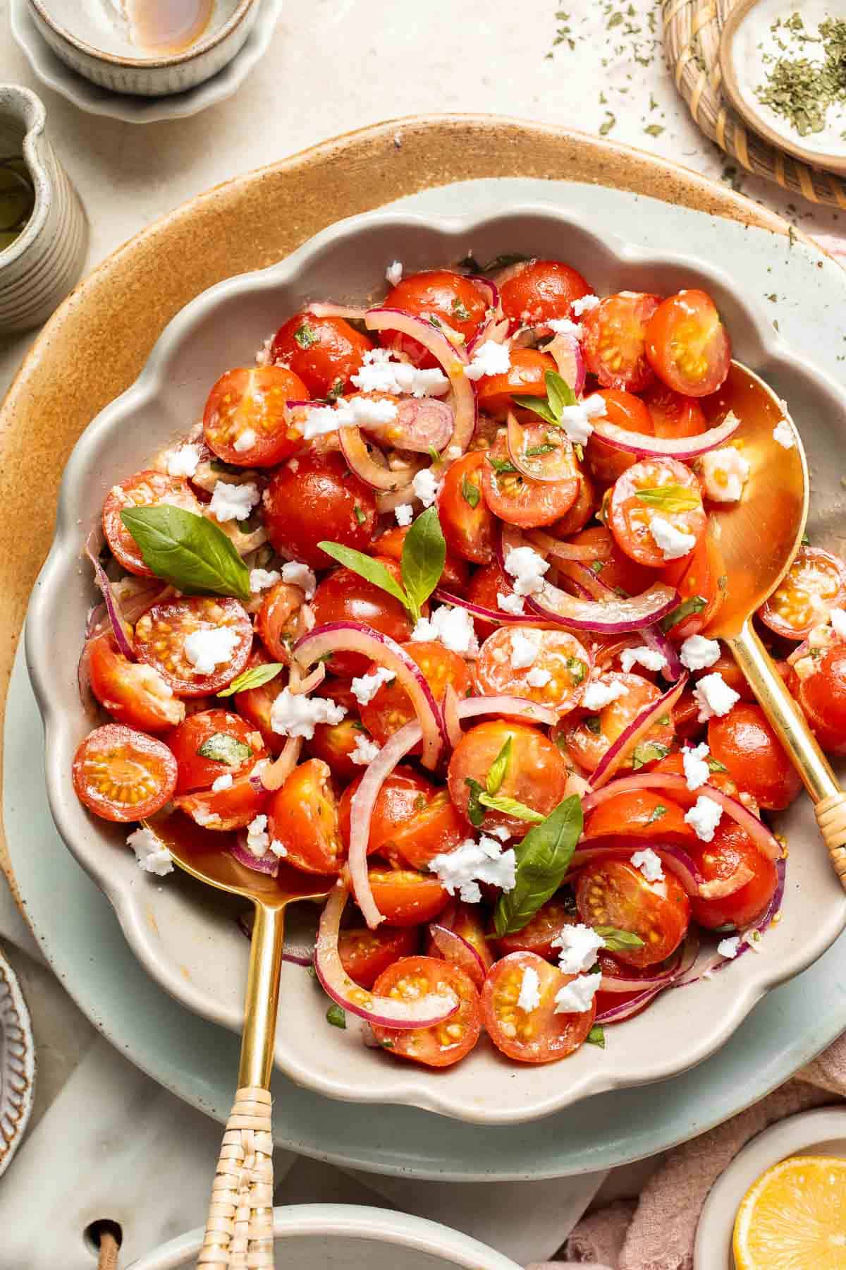 This quick and easy Cherry Tomato Salad is made with sweet cherry tomatoes, red onion, fresh basil, and feta cheese tossed in a simple vinaigrette. | aheadofthyme.com