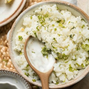 This simple Greek Rice is lemony, full of herbs, and warm, delicious flavors — and it couldn't be much easier to make. Our go-to fluffy herb rice dish! | aheadofthyme.com