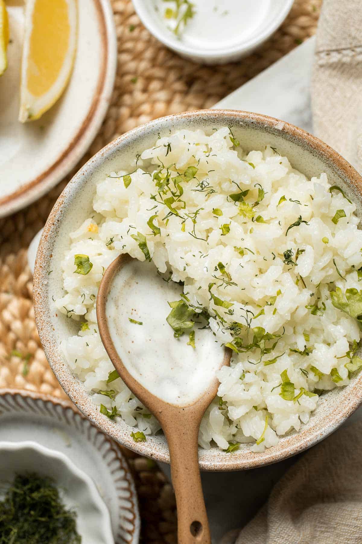 This simple Greek Rice is lemony, full of herbs, and warm, delicious flavors — and it couldn't be much easier to make. Our go-to fluffy herb rice dish! | aheadofthyme.com