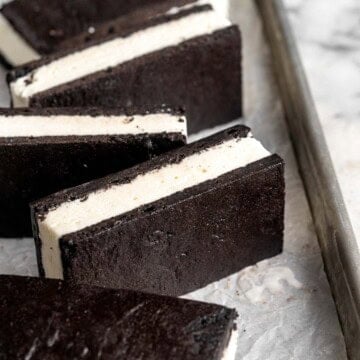 Homemade Ice Cream Sandwiches are made with creamy vanilla ice cream perfectly nestled between two tender homemade chocolate cookies. | aheadofthyme.com
