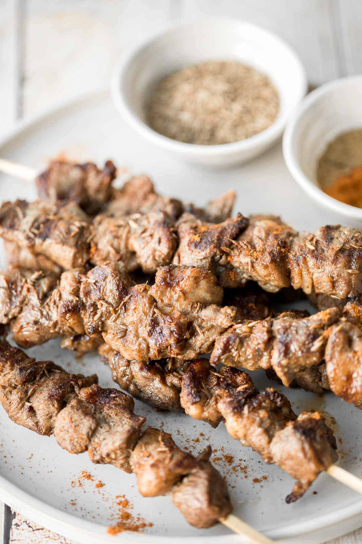 Juicy and tender, Xinjiang Spicy Cumin Lamb Skewers with a bold cumin and cayenne marinade, are so flavourful and easy to make on the grill or air fryer. | aheadofthyme.com