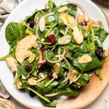 This Spinach Salad is a healthy and easy to make fall recipe with spinach, apples, cranberries, pecans, and feta tossed in homemade balsamic vinaigrette. | aheadofthyme.com