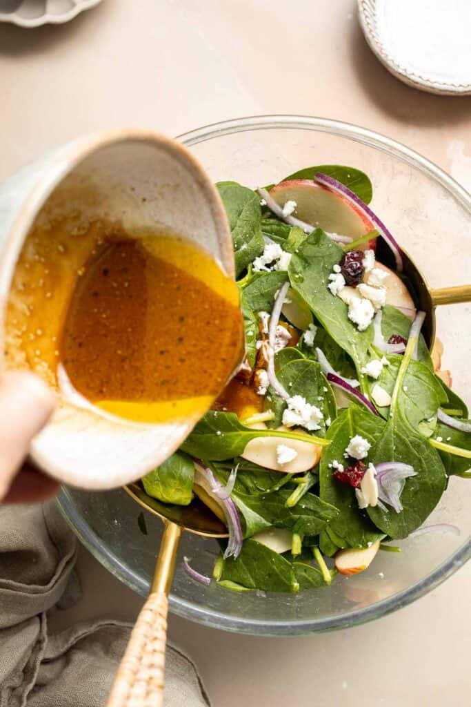 This Spinach Salad is a healthy and easy to make fall recipe with spinach, apples, cranberries, pecans, and feta tossed in homemade balsamic vinaigrette. | aheadofthyme.com