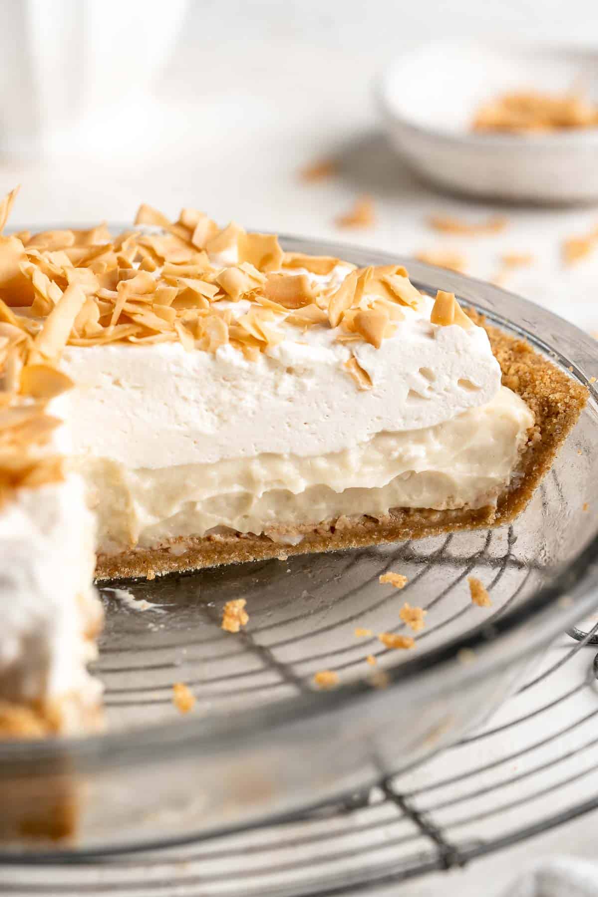 This Coconut Cream Pie made from scratch features a graham cracker crust topped with a creamy homemade coconut pudding filling and freshly whipped cream. | aheadofthyme.com