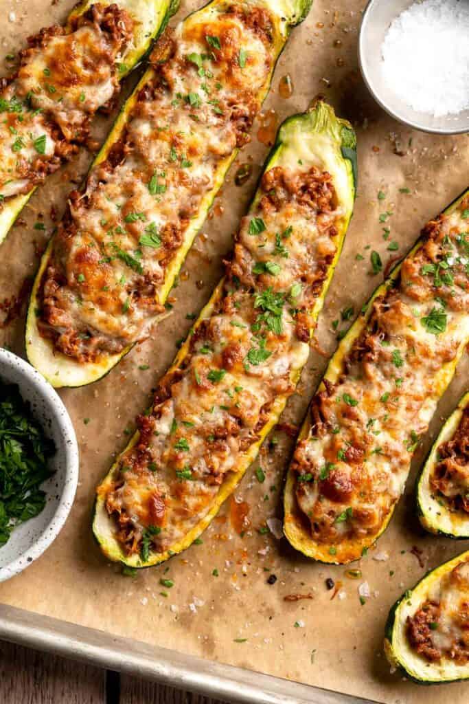 Stuffed Zucchini Boats are a fun, low carb dinner filled with a hearty meat sauce, topped with cheese, and baked until melty and bubbly. | aheadofthyme.com